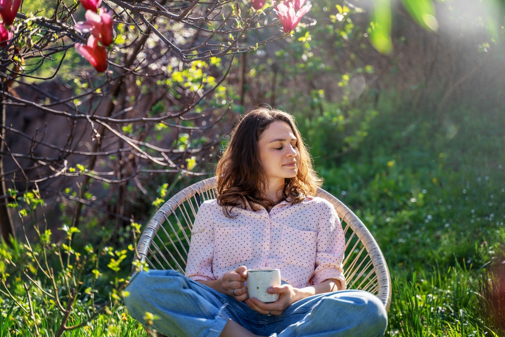 Young,Beautiful,Woman,Enjoying,Relaxing,In,The,Spring,While,Sitting