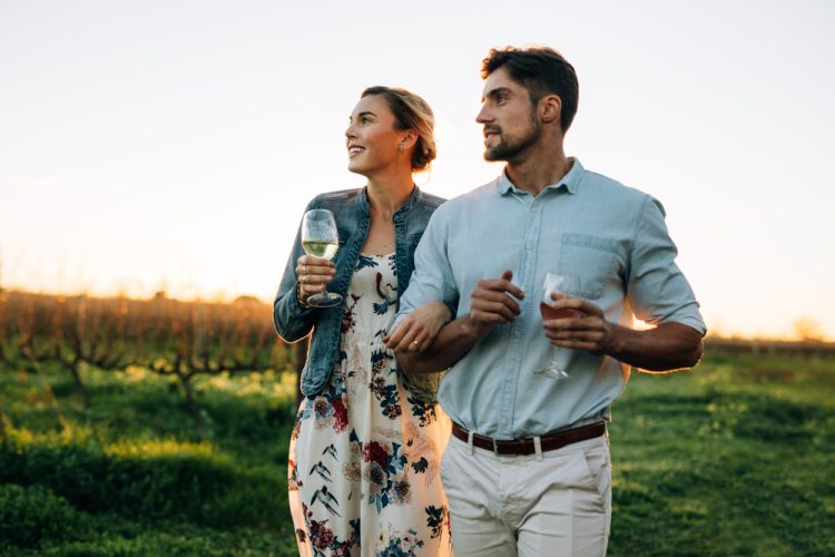 Man,And,Woman,With,A,Drink,Walking,Outdoors.,Couple,Together